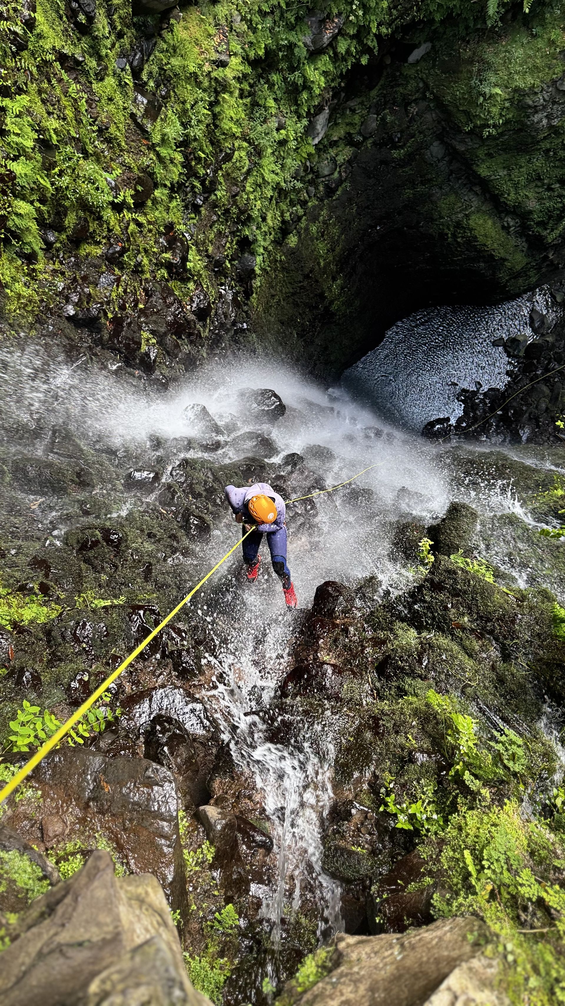 Rappelling down waterfall on Madeira canyoning adventure