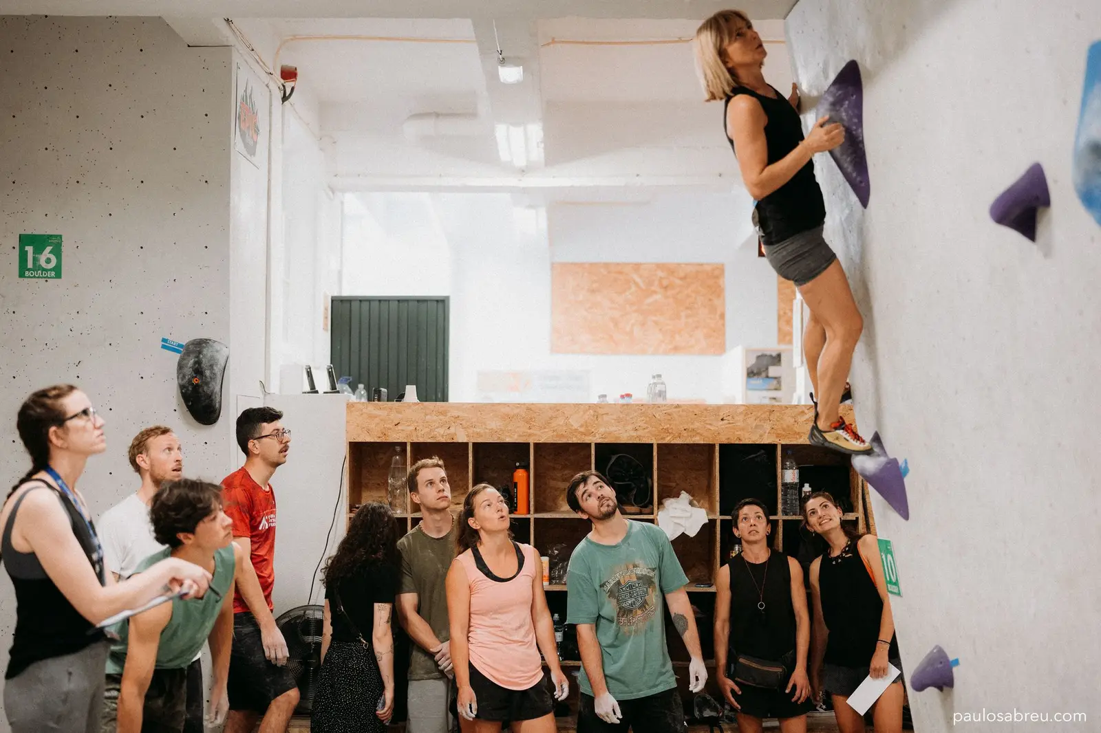 Climber on dynamic boulder move at Madeira gym